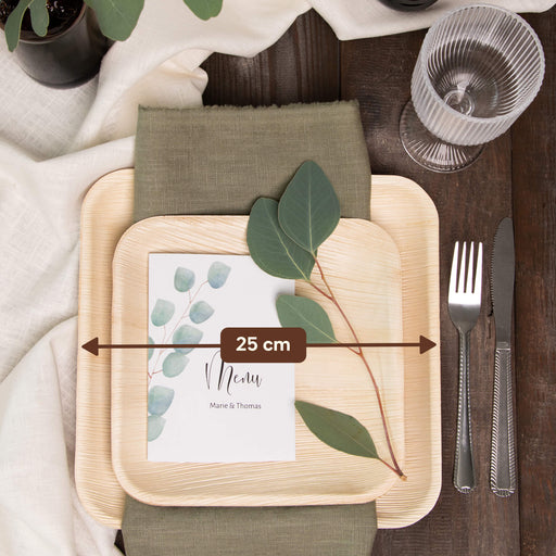 Tischgedeck mit Palmblatttellern, Serviette, Menükarte und für eine Festtafel